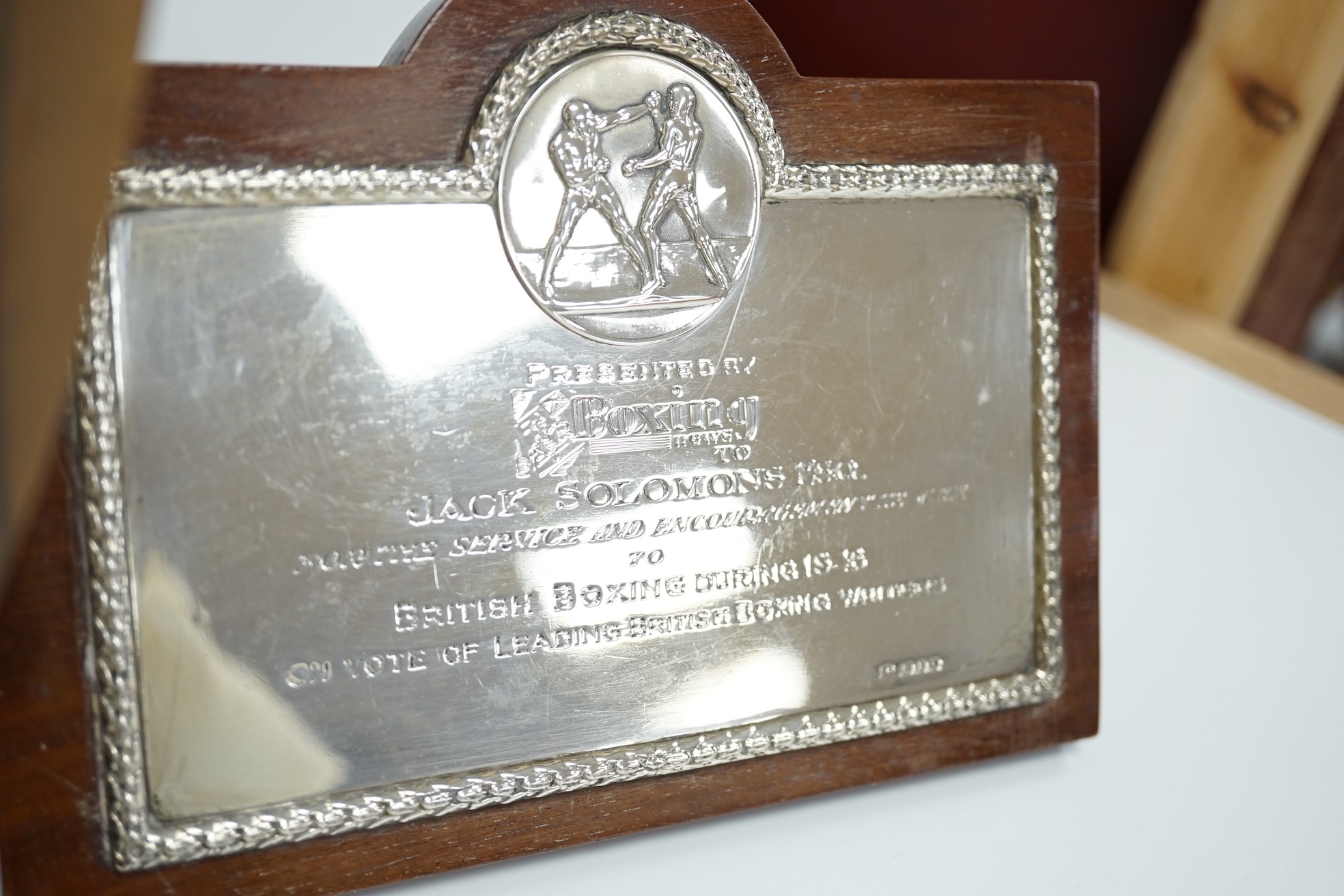 A 1940's engraved silver mounted wooden plaque, presented by Boxing News to Jack Solomons , London, 1946, plaque width 16.3cm, together with a brass mounted Israel Boxing Team plaque, to Jack & Fay Solomons. Condition -